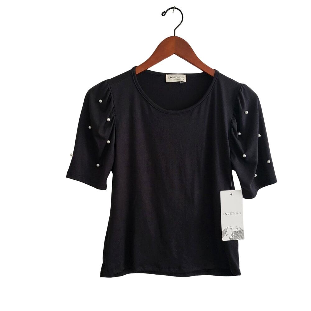 New Love wins black tee with pearl sleeves